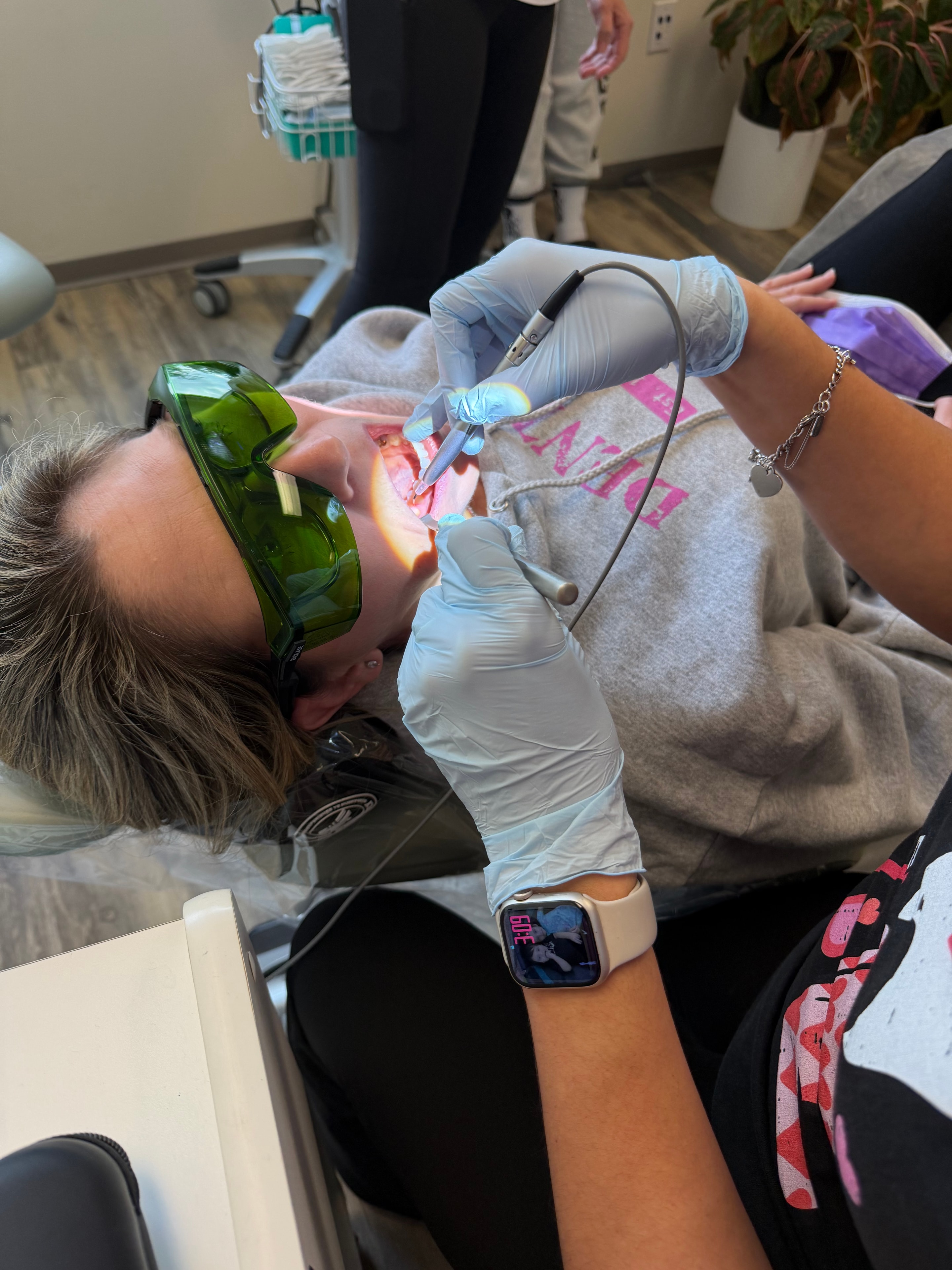 Dental professional practicing laser technique during hands-on training session